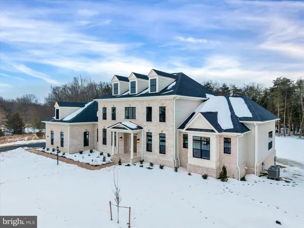 a view of a white house with a snow on the road