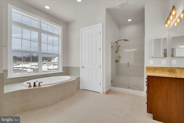 a bathroom with a sink vanity mirror and toilet