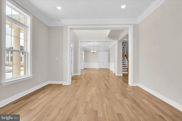 a large kitchen with stainless steel appliances granite countertop a stove a sink dishwasher and a oven with white cabinets