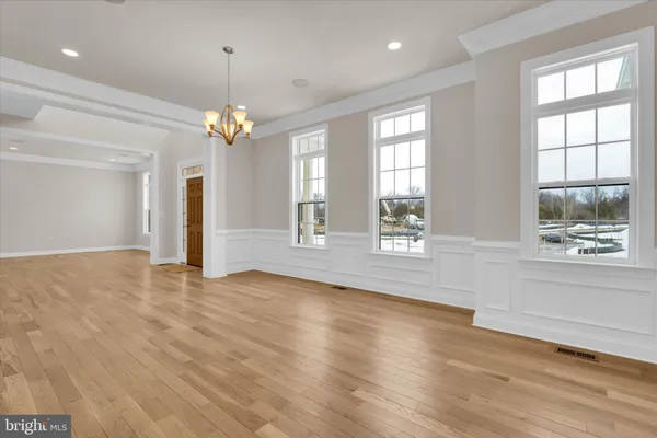 a large kitchen with stainless steel appliances granite countertop a lot of counter space and wooden floors