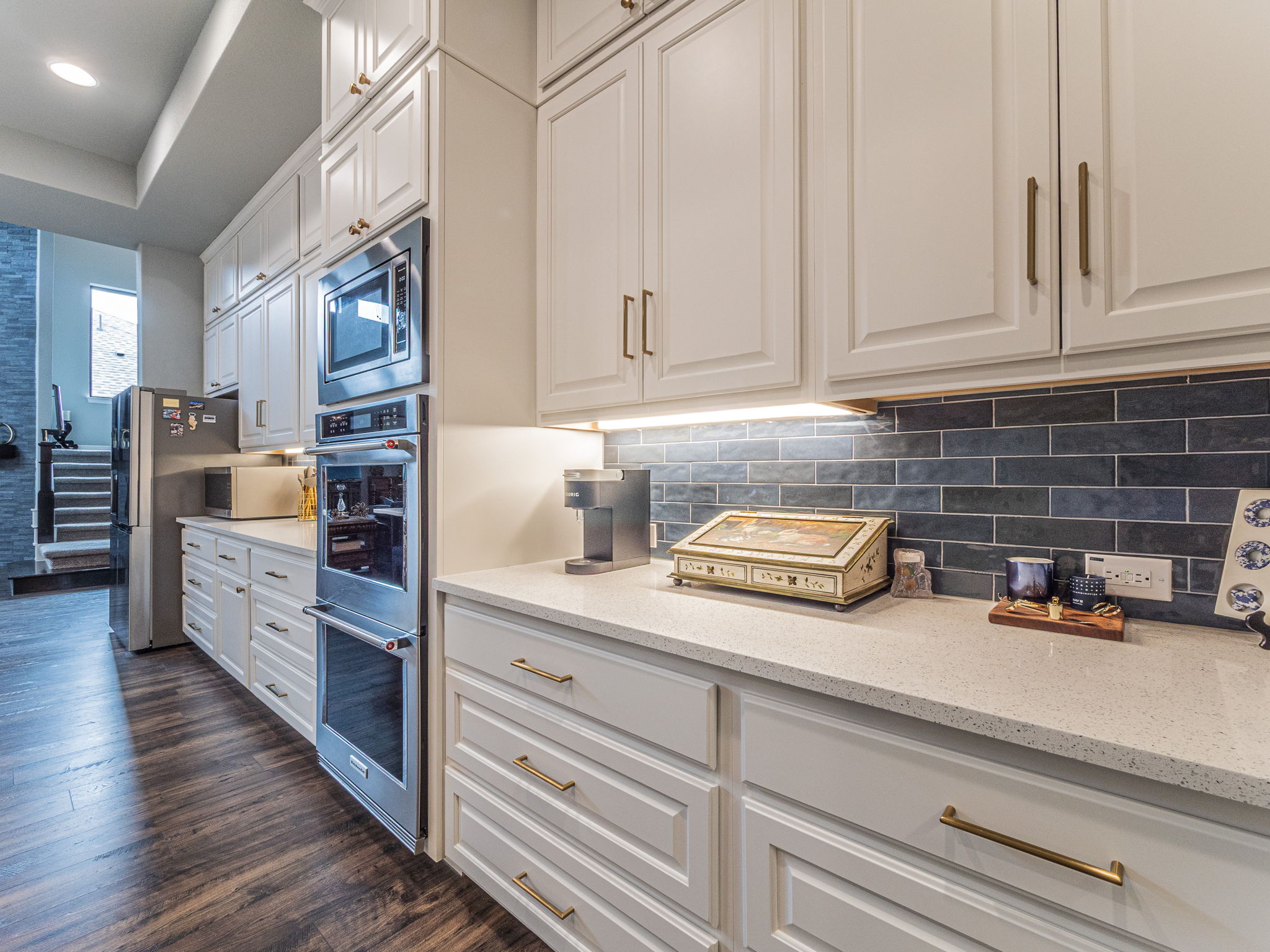 112 Hollytree Court Georgetown, TX 78628 - Photo 10 of 40 a kitchen with cabinets wooden floor and stainless steel appliances