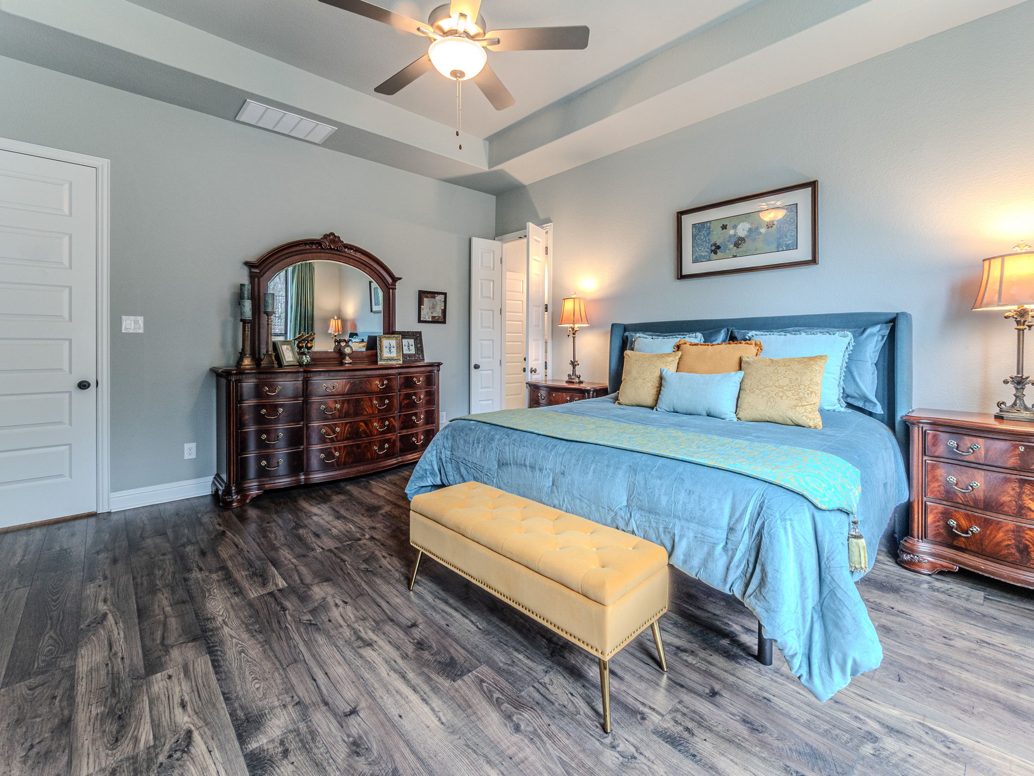 112 Hollytree Court Georgetown, TX 78628 - Photo 14 of 40 Bedroom with wood finished floors, a raised ceiling, and a ceiling fan