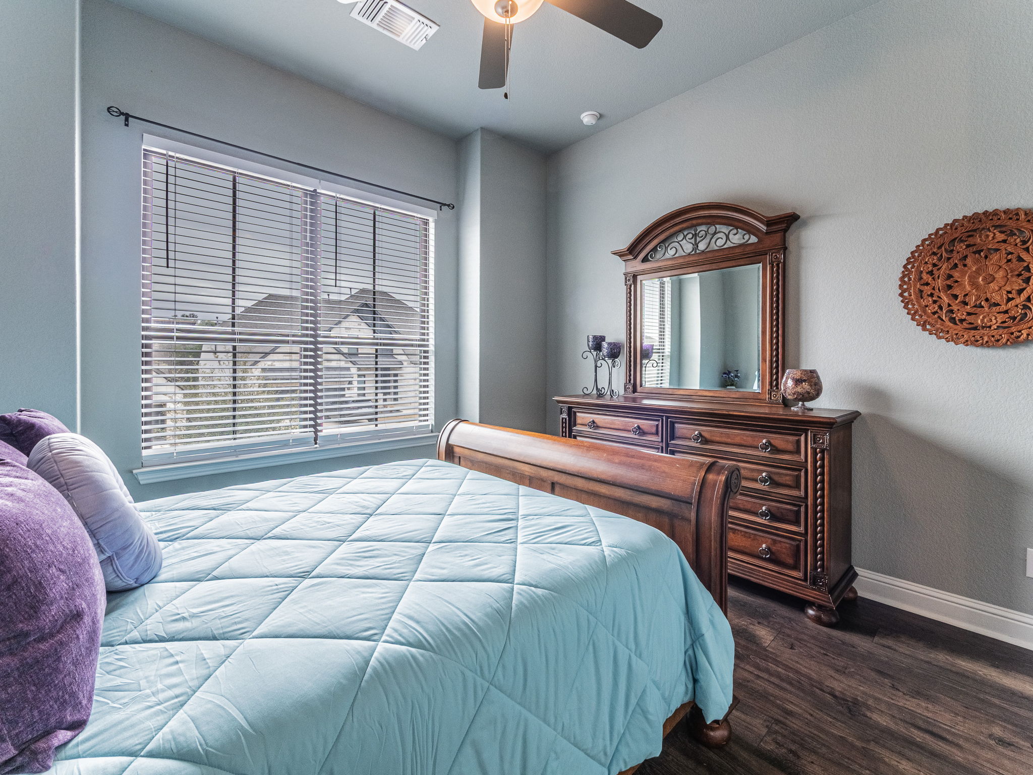 112 Hollytree Court Georgetown, TX 78628 - Photo 19 of 40 a bedroom with a bed and a large mirror on the dresser