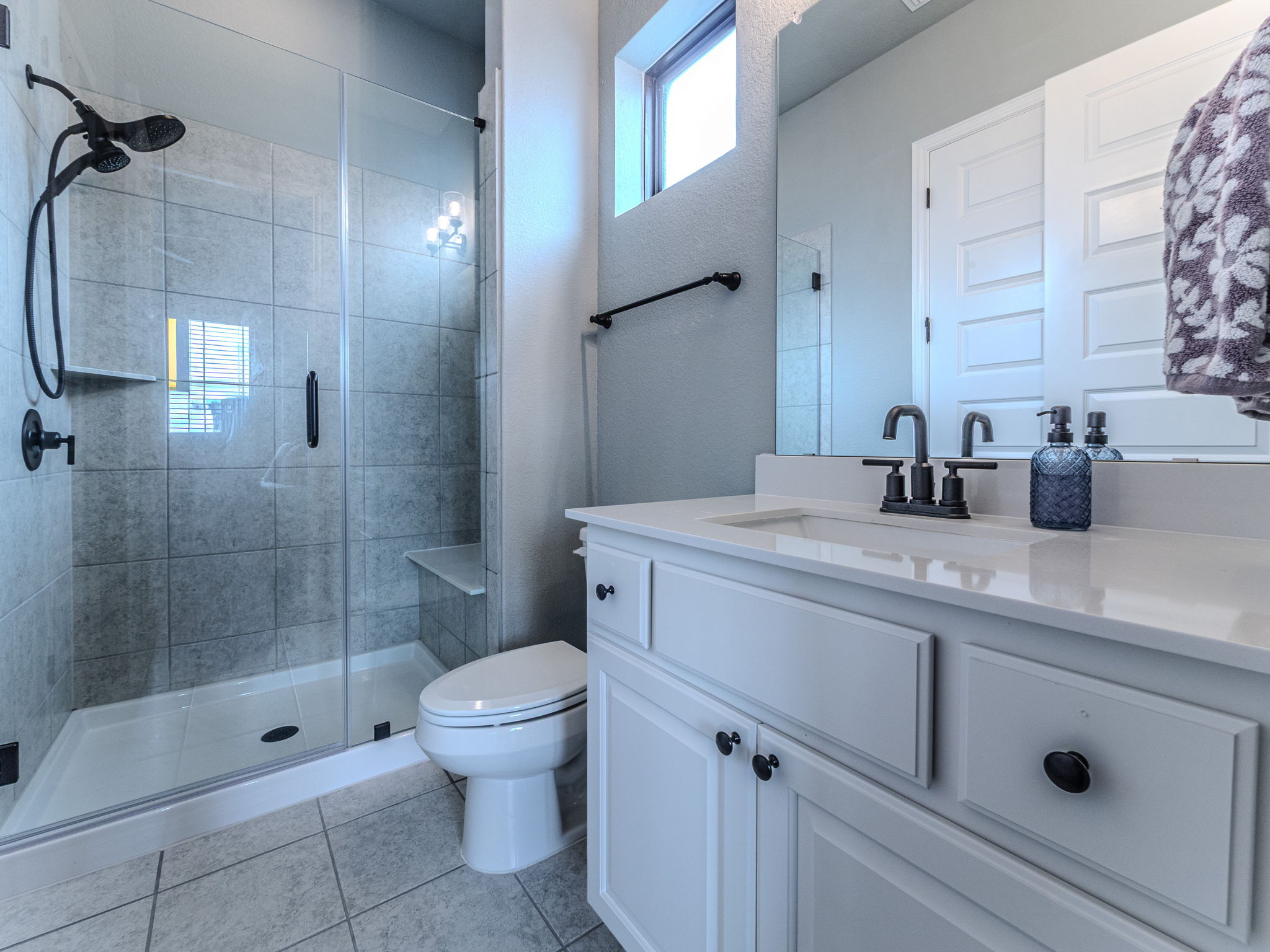 112 Hollytree Court Georgetown, TX 78628 - Photo 20 of 40 a bathroom with a shower sink vanity mirror and toilet