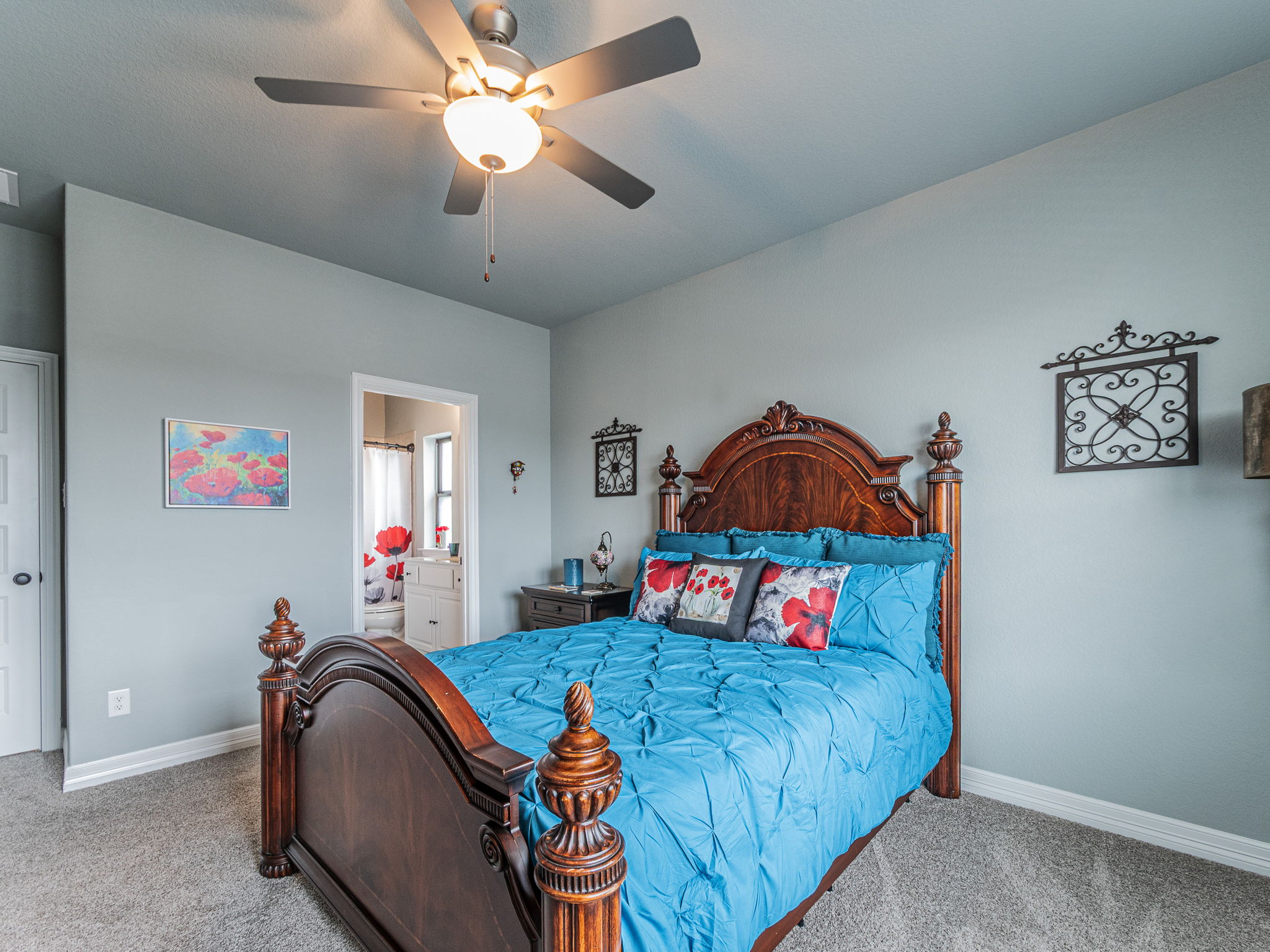 112 Hollytree Court Georgetown, TX 78628 - Photo 26 of 40 a bedroom with a bed and a chandelier
