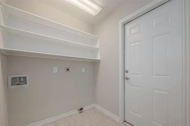 an empty room with chandelier fan and windows