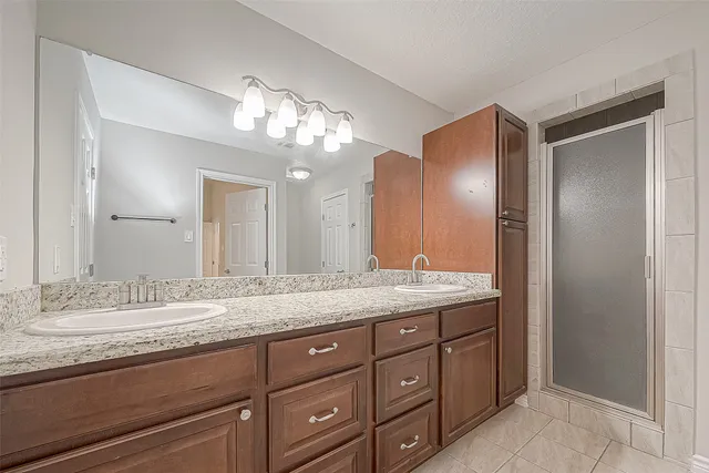 a bathroom with a granite countertop sink a mirror and a