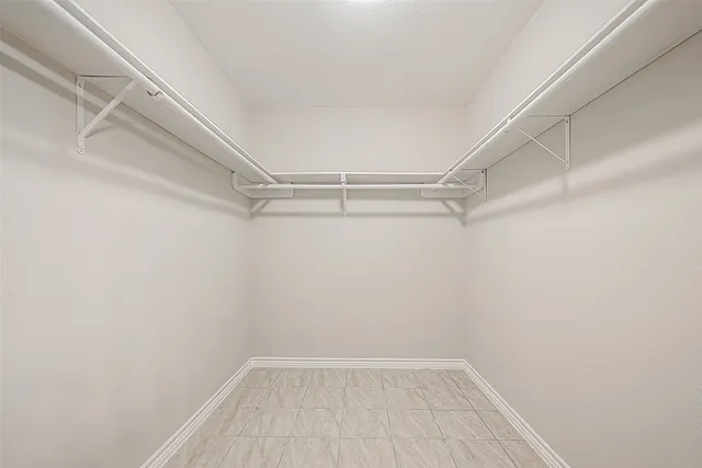 a bathroom with double vanity and a mirror