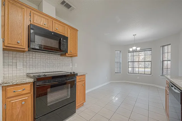 a kitchen with a sink stove and cabinets