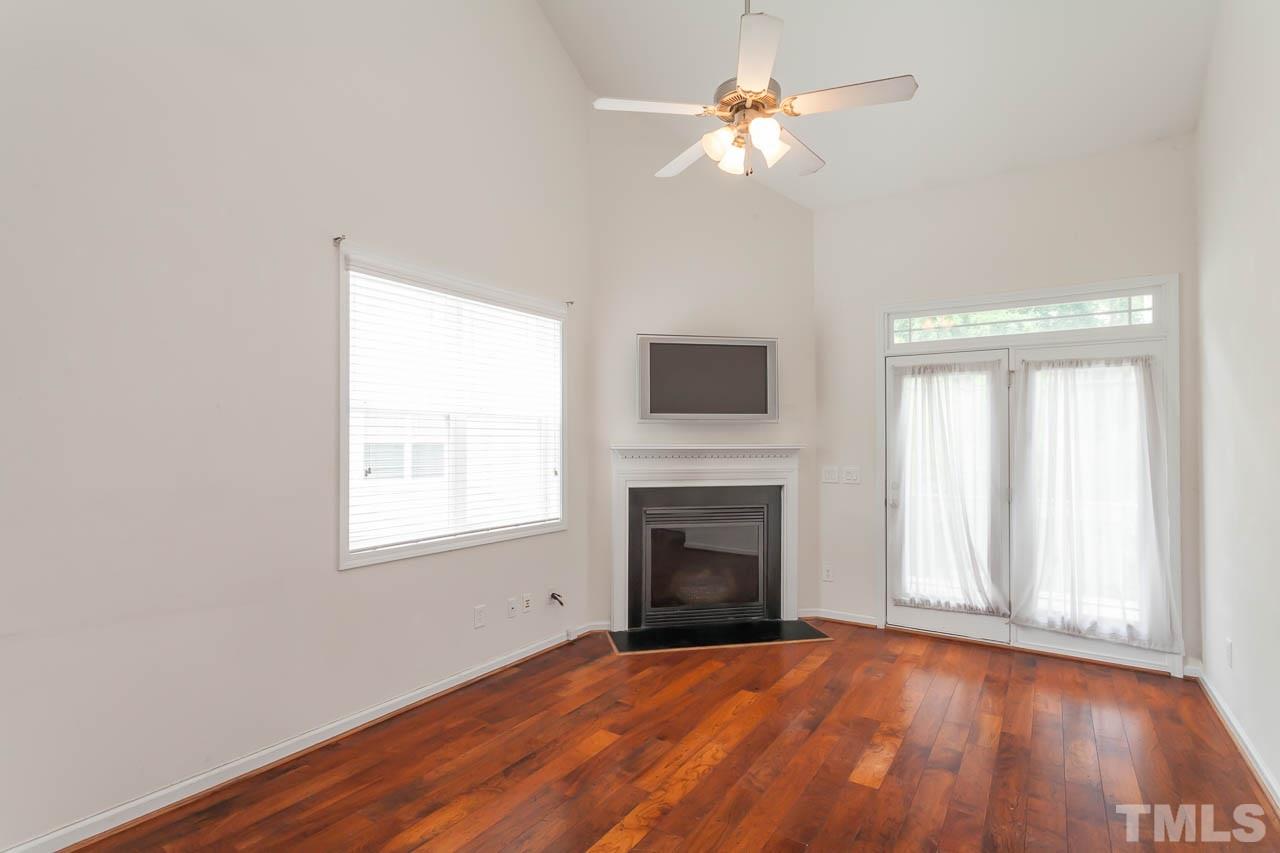 4708 Altha Street Raleigh, NC 27606 - Photo 12 of 25 an empty room with windows and fireplace