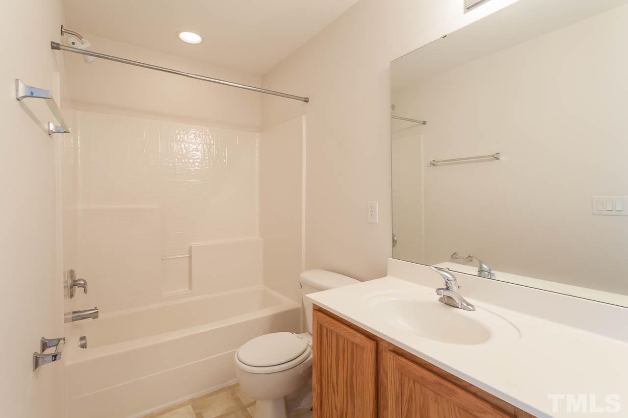 4708 Altha Street Raleigh, NC 27606 - Photo 18 of 25 a bathroom with a sink toilet and shower