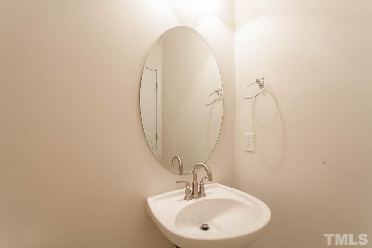 4708 Altha Street Raleigh, NC 27606 - Photo 19 of 25 a bathroom with a sink and mirror