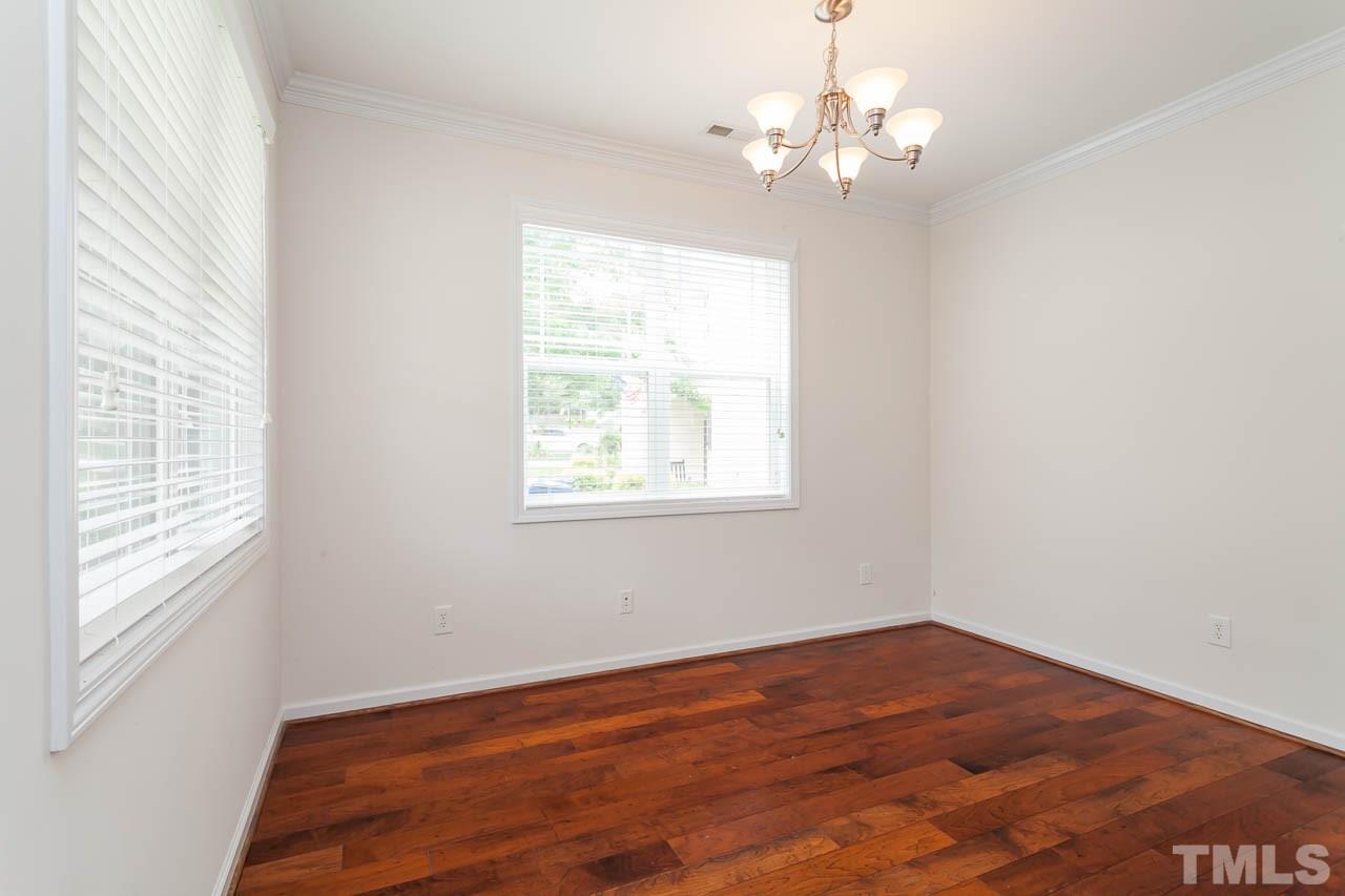 4708 Altha Street Raleigh, NC 27606 - Photo 6 of 25 wooden floor in an empty room with a window