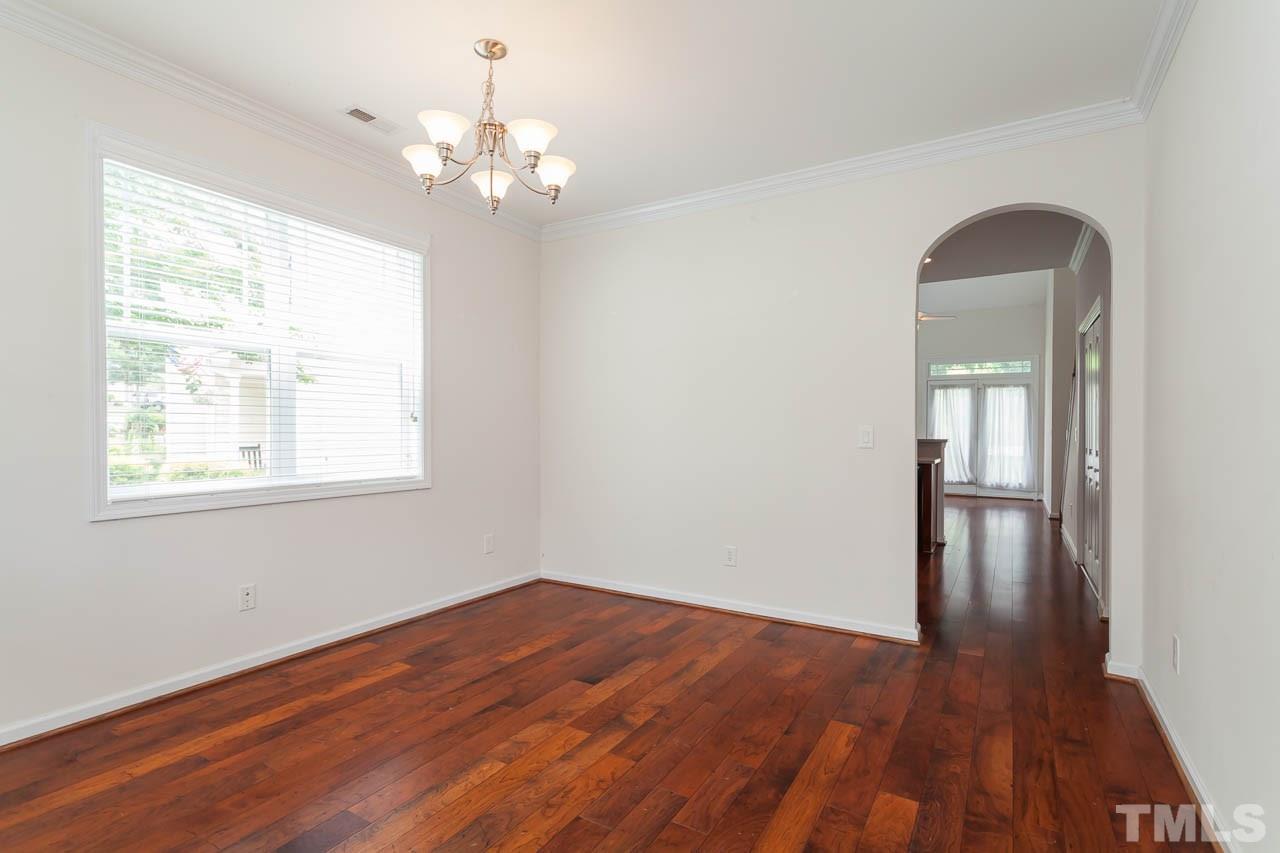 4708 Altha Street Raleigh, NC 27606 - Photo 7 of 25 a view of livingroom with wooden floor and chandelier