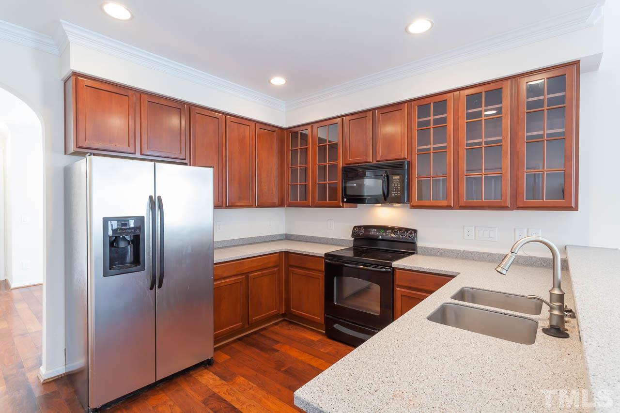 4708 Altha Street Raleigh, NC 27606 - Photo 9 of 25 a kitchen that has a sink stainless steel appliances and cabinets
