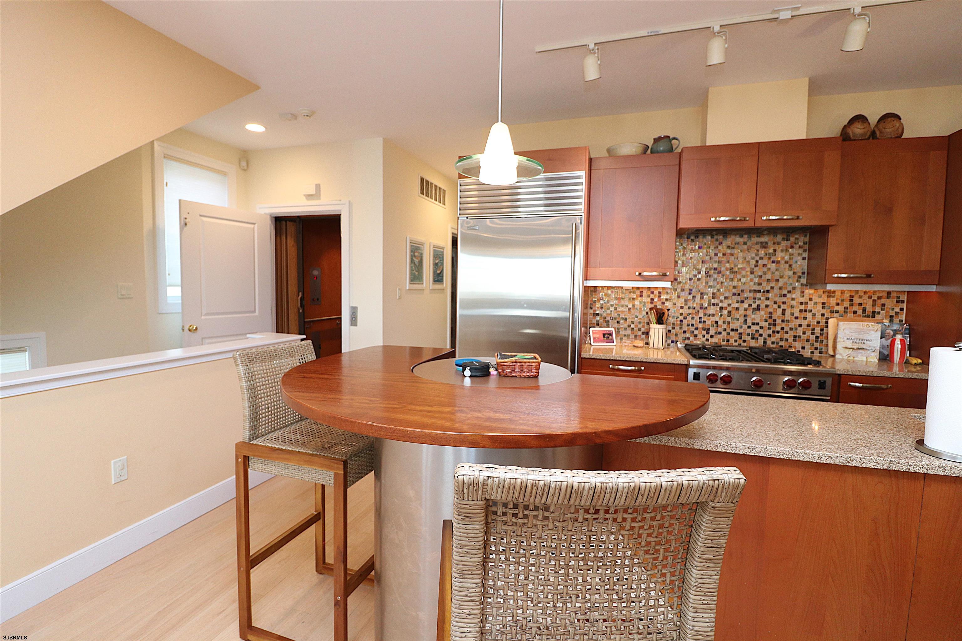 214 North Decatur Avenue, Unit B Margate City, NJ 08402 - Photo 17 of 23 a kitchen with kitchen island granite countertop a sink and a stove