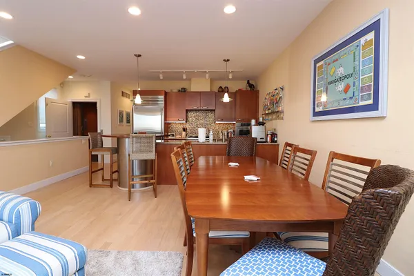 a dining room with furniture and wooden floor