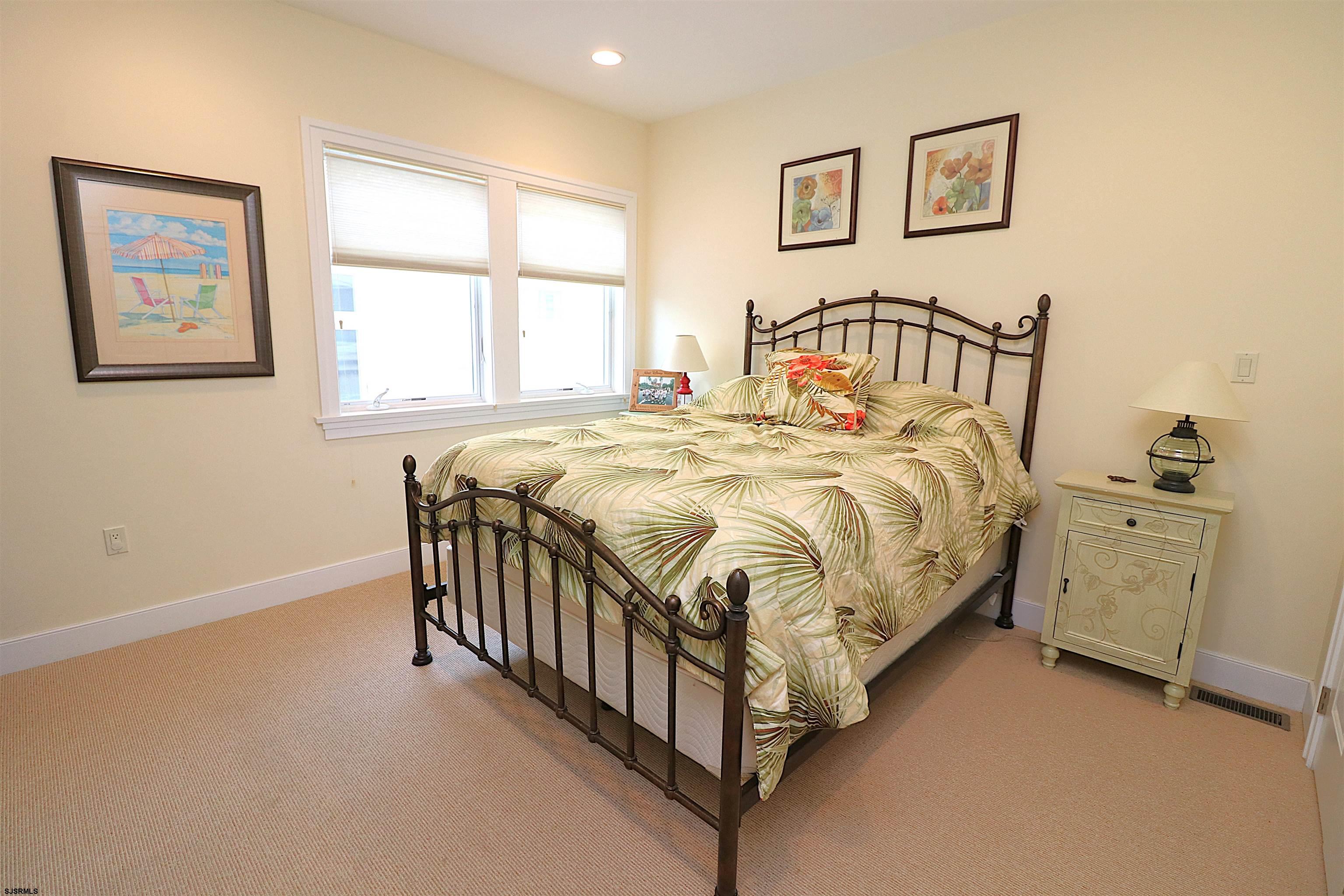 214 North Decatur Avenue, Unit B Margate City, NJ 08402 - Photo 22 of 23 a bedroom with a bed and a window