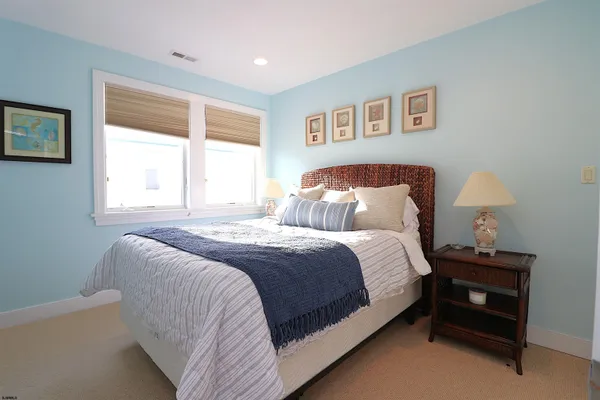 a bedroom with a bed and a night stand