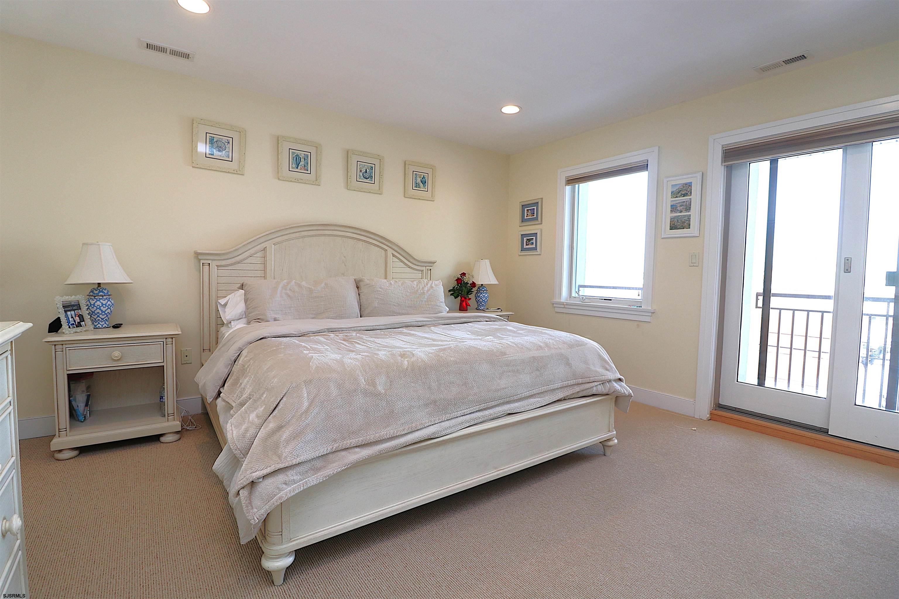 214 North Decatur Avenue, Unit B Margate City, NJ 08402 - Photo 4 of 23 a spacious bedroom with a bed and a window