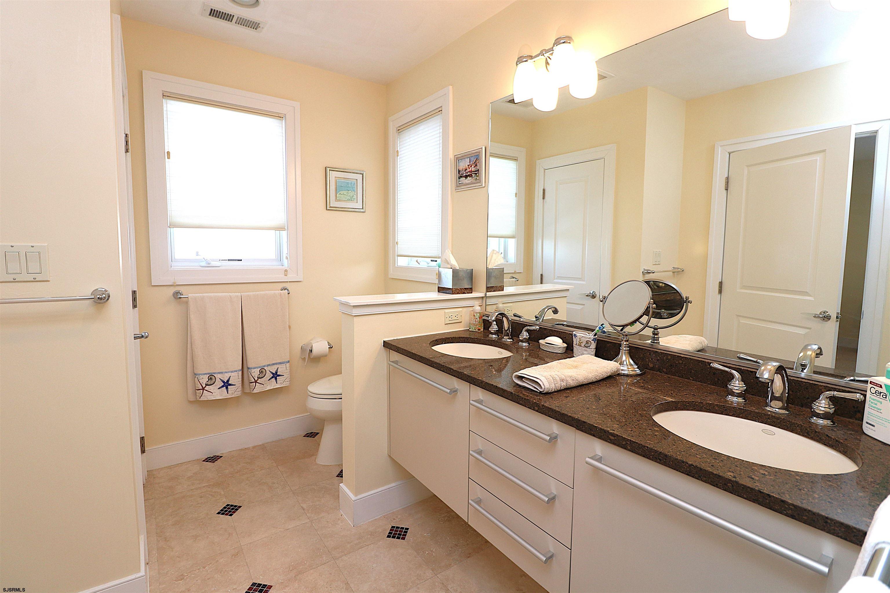 214 North Decatur Avenue, Unit B Margate City, NJ 08402 - Photo 6 of 23 a bathroom with a double vanity sink mirror and double