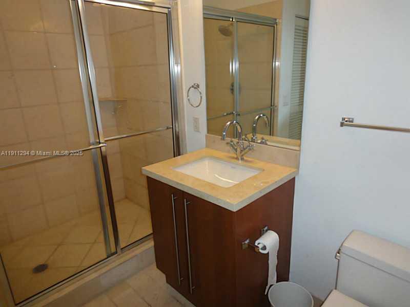 1111 Southwest 1st Avenue, Unit 1123N Miami, FL 33130 - Photo 14 of 16 a bathroom with a sink a toilet and shower