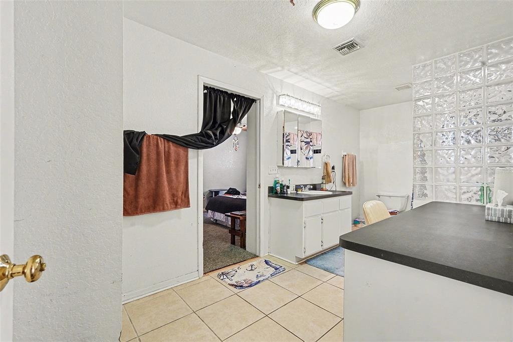 9528 River Road Spring Hill, FL 34608 - Photo 11 of 30 a kitchen with granite countertop a sink a stove and cabinets