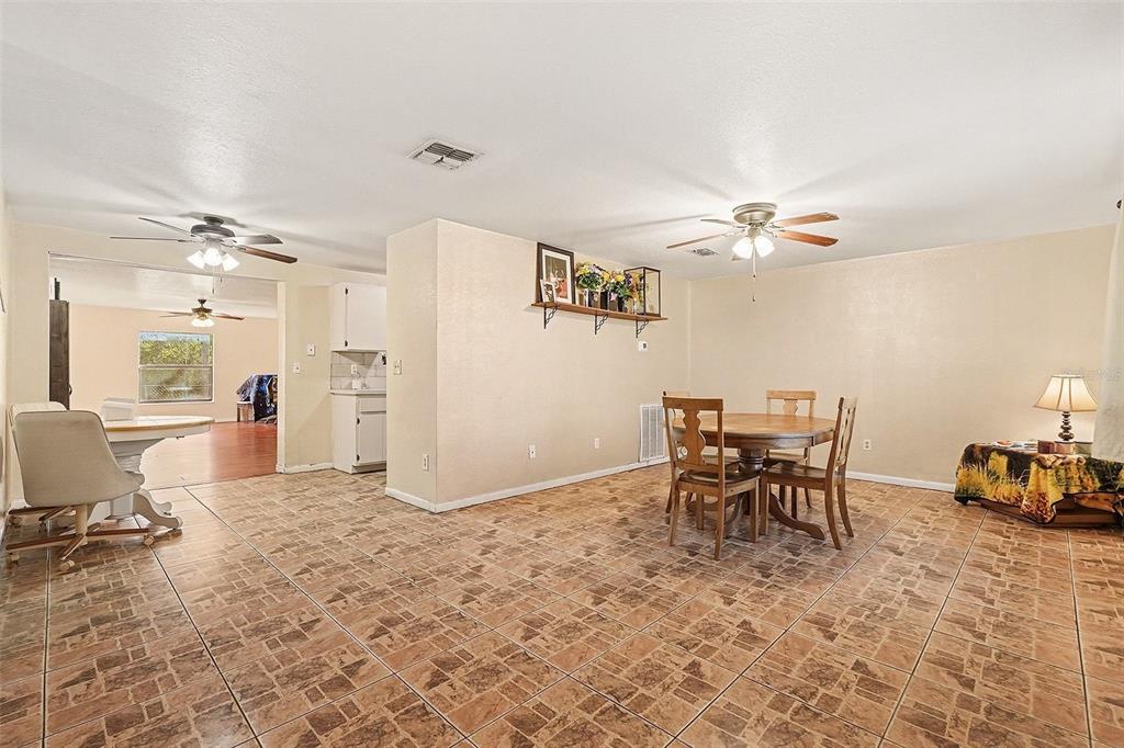 9528 River Road Spring Hill, FL 34608 - Photo 14 of 30 a view of a livingroom with furniture and a dining table chairs