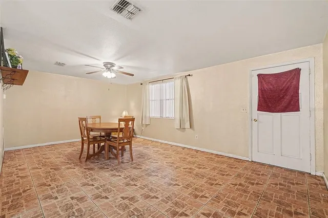 a view of a livingroom with furniture and chandelier fan