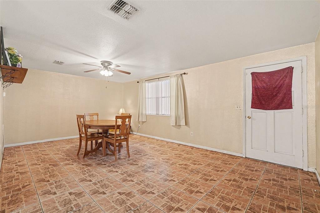 9528 River Road Spring Hill, FL 34608 - Photo 15 of 30 a view of a livingroom with furniture and chandelier fan