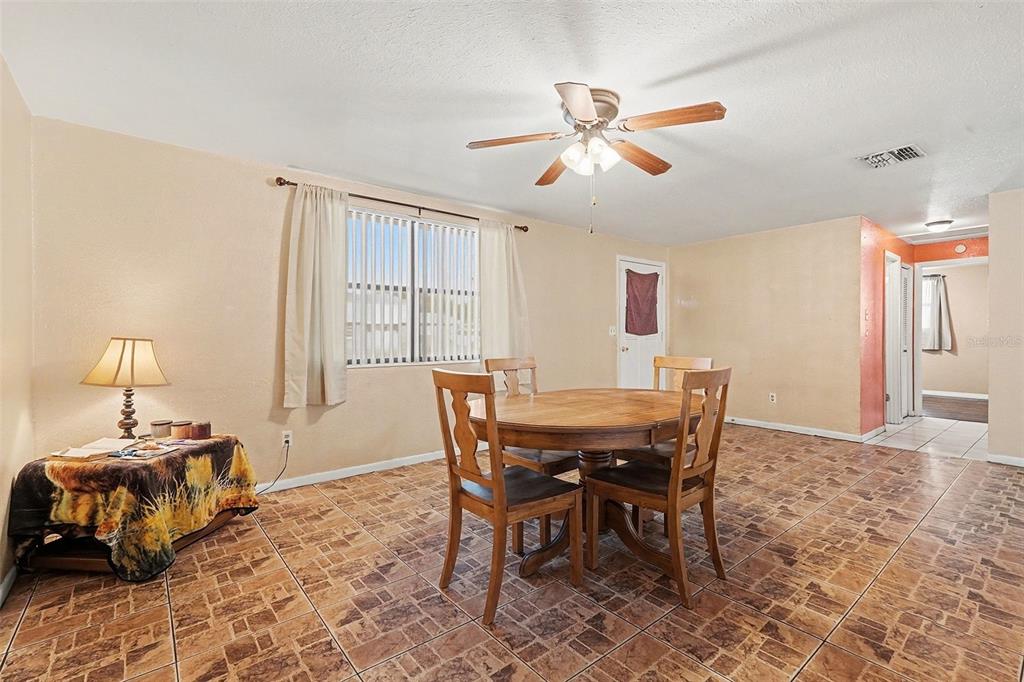 9528 River Road Spring Hill, FL 34608 - Photo 16 of 30 a view of a dining room with furniture