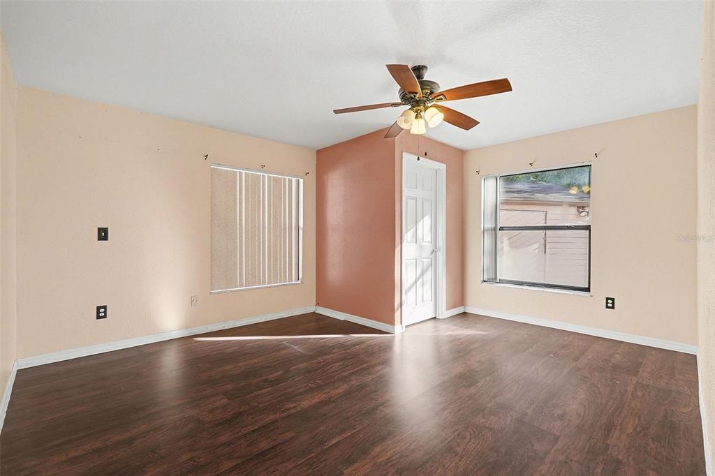 9528 River Road Spring Hill, FL 34608 - Photo 17 of 30 a view of an empty room with window and wooden floor