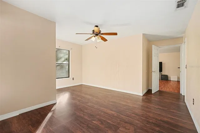 wooden floor in an empty room with a window