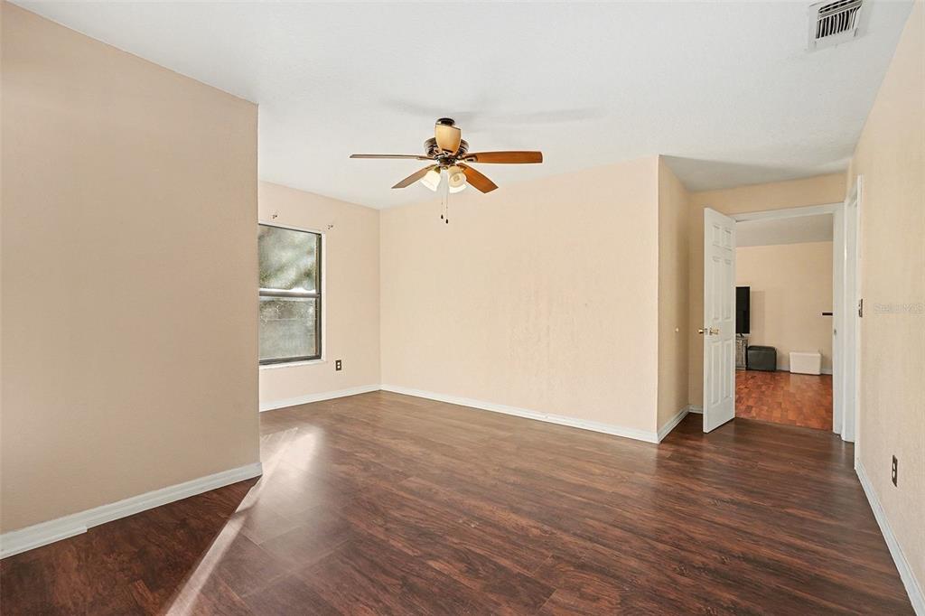 9528 River Road Spring Hill, FL 34608 - Photo 18 of 30 wooden floor in an empty room with a window