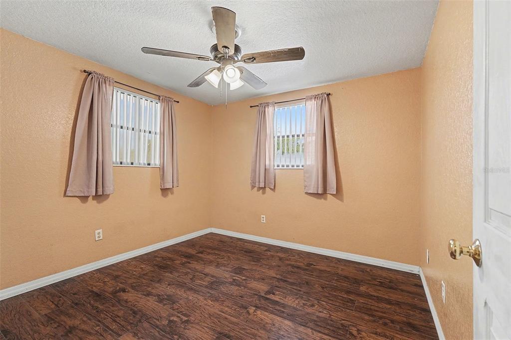 9528 River Road Spring Hill, FL 34608 - Photo 21 of 30 a view of empty room with wooden floor and fan