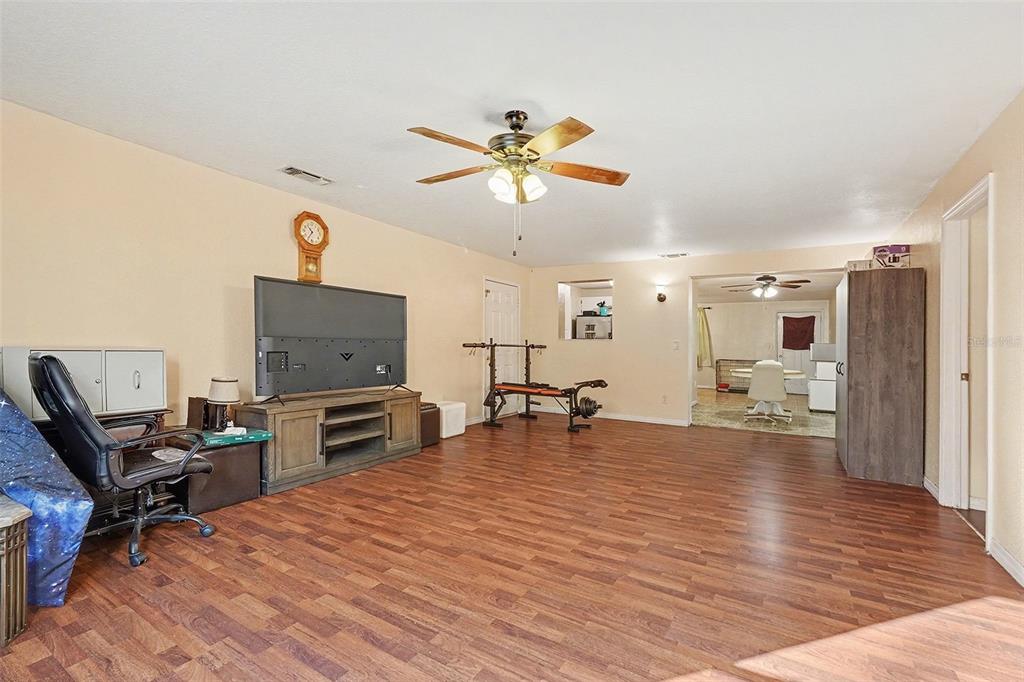 9528 River Road Spring Hill, FL 34608 - Photo 4 of 30 a living room with furniture and a flat screen tv