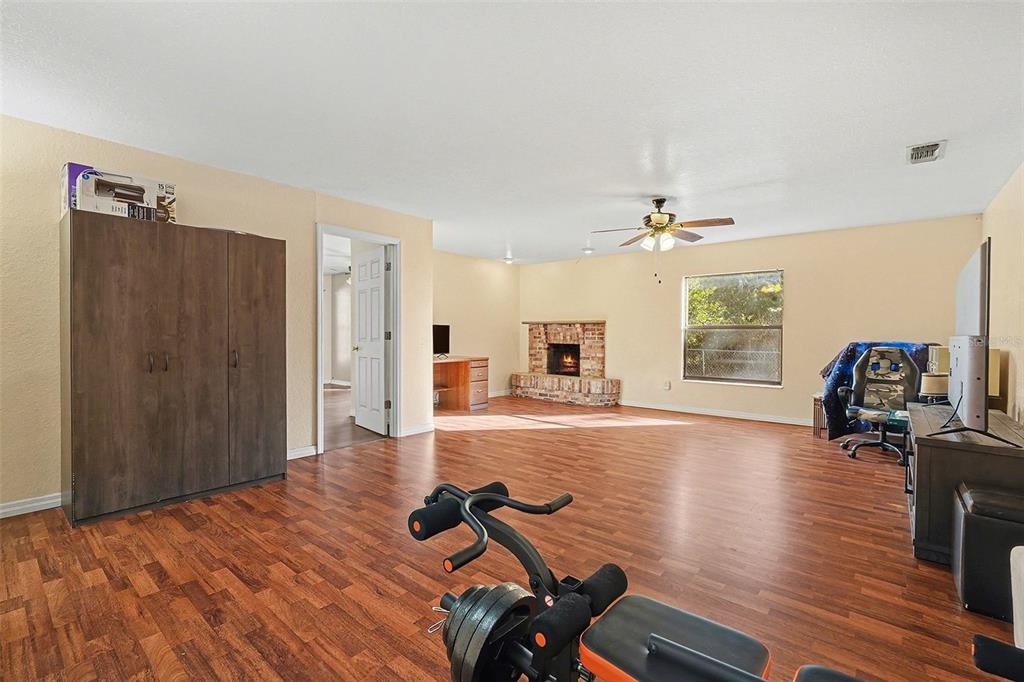 9528 River Road Spring Hill, FL 34608 - Photo 5 of 30 a view of a livingroom with furniture hardwood floor and hallway