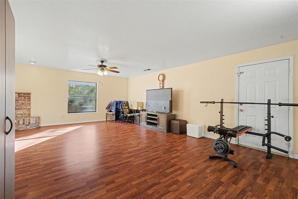 9528 River Road Spring Hill, FL 34608 - Photo 6 of 30 a view of a livingroom with furniture and a flat screen tv