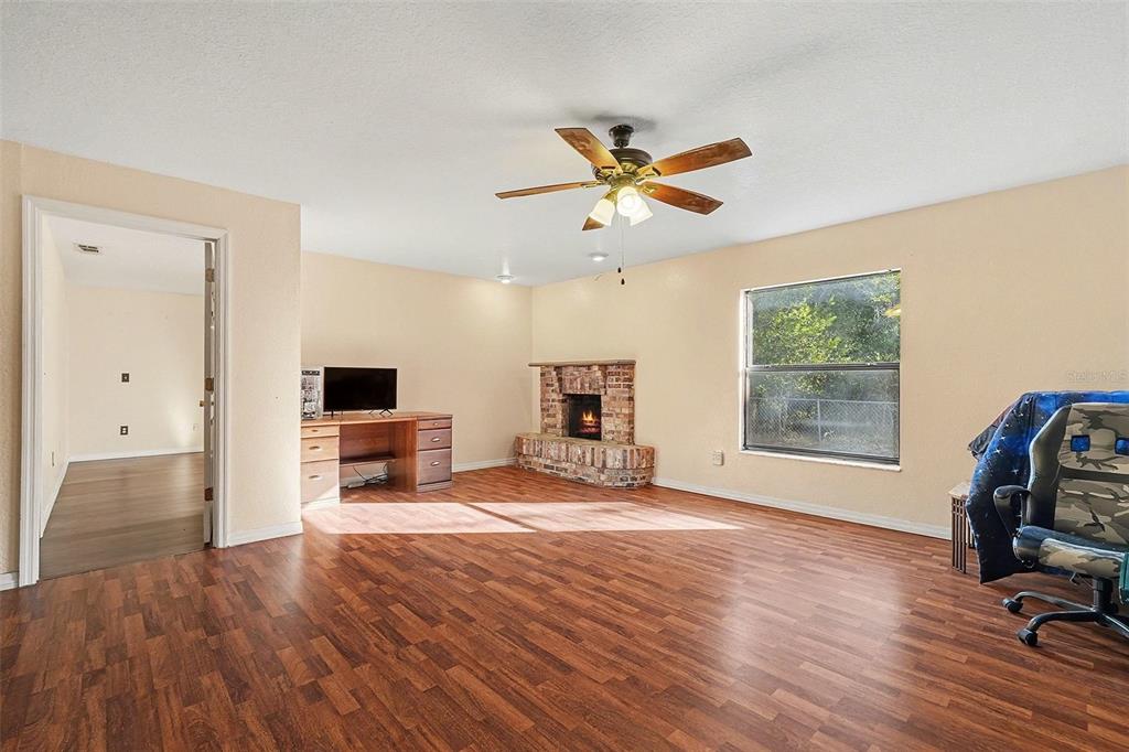9528 River Road Spring Hill, FL 34608 - Photo 7 of 30 a view of a workspace with furniture and a window