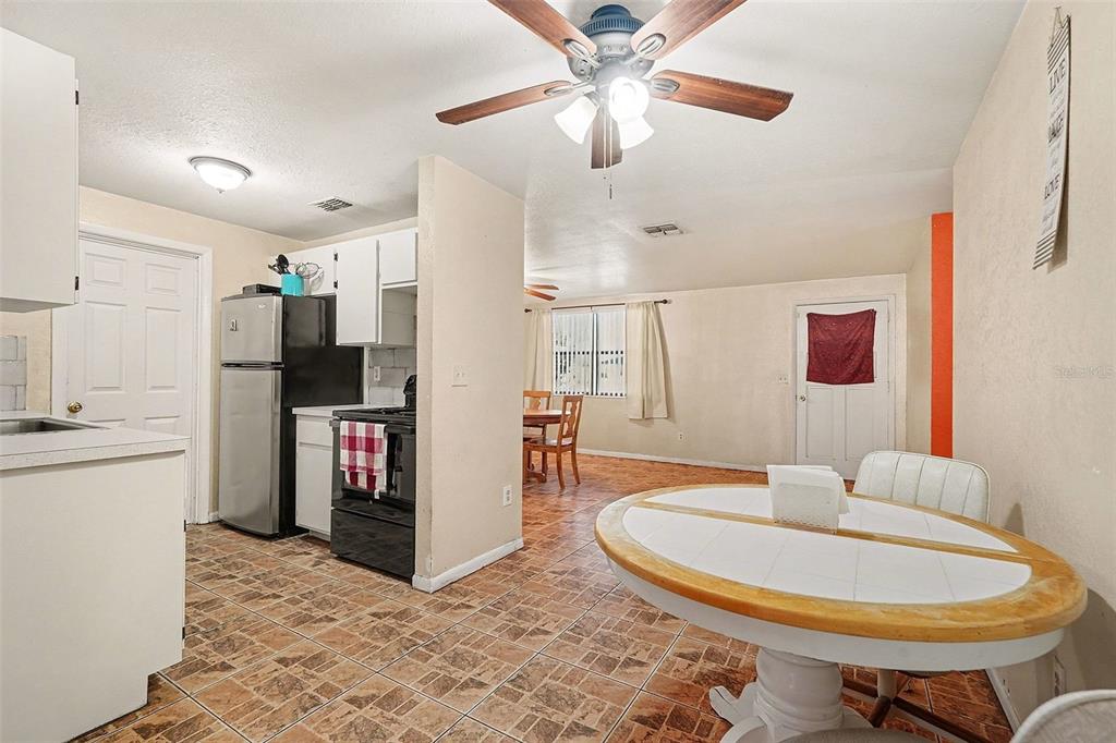 9528 River Road Spring Hill, FL 34608 - Photo 8 of 30 a living room with stainless steel appliances furniture and a kitchen view