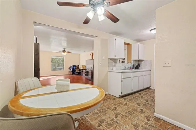 a kitchen with stainless steel appliances kitchen island granite countertop a cabinets and wooden floor