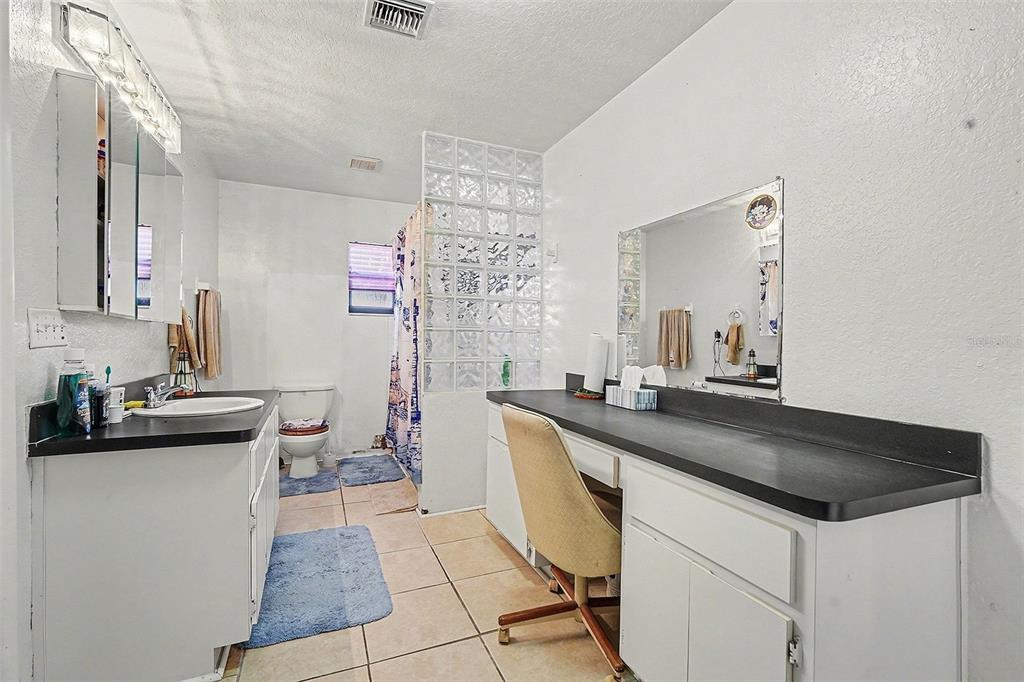 9528 River Road Spring Hill, FL 34608 - Photo 10 of 30 a kitchen with a sink and a stove top oven