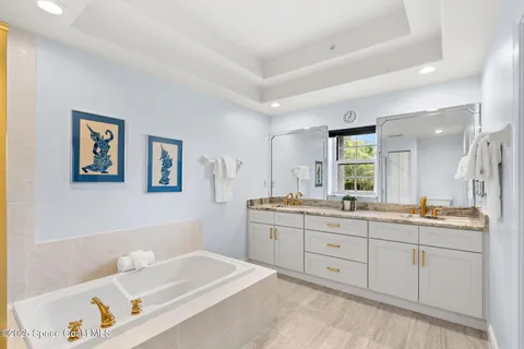 a spacious bathroom with a granite countertop sink mirror and a