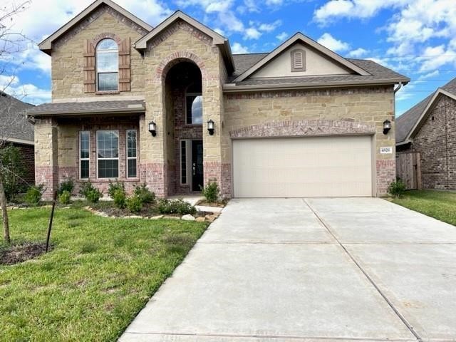 4826 Albany Ridge Lane Rosharon, TX 77583 - Photo 2 of 37 a front view of a house with a yard and garage