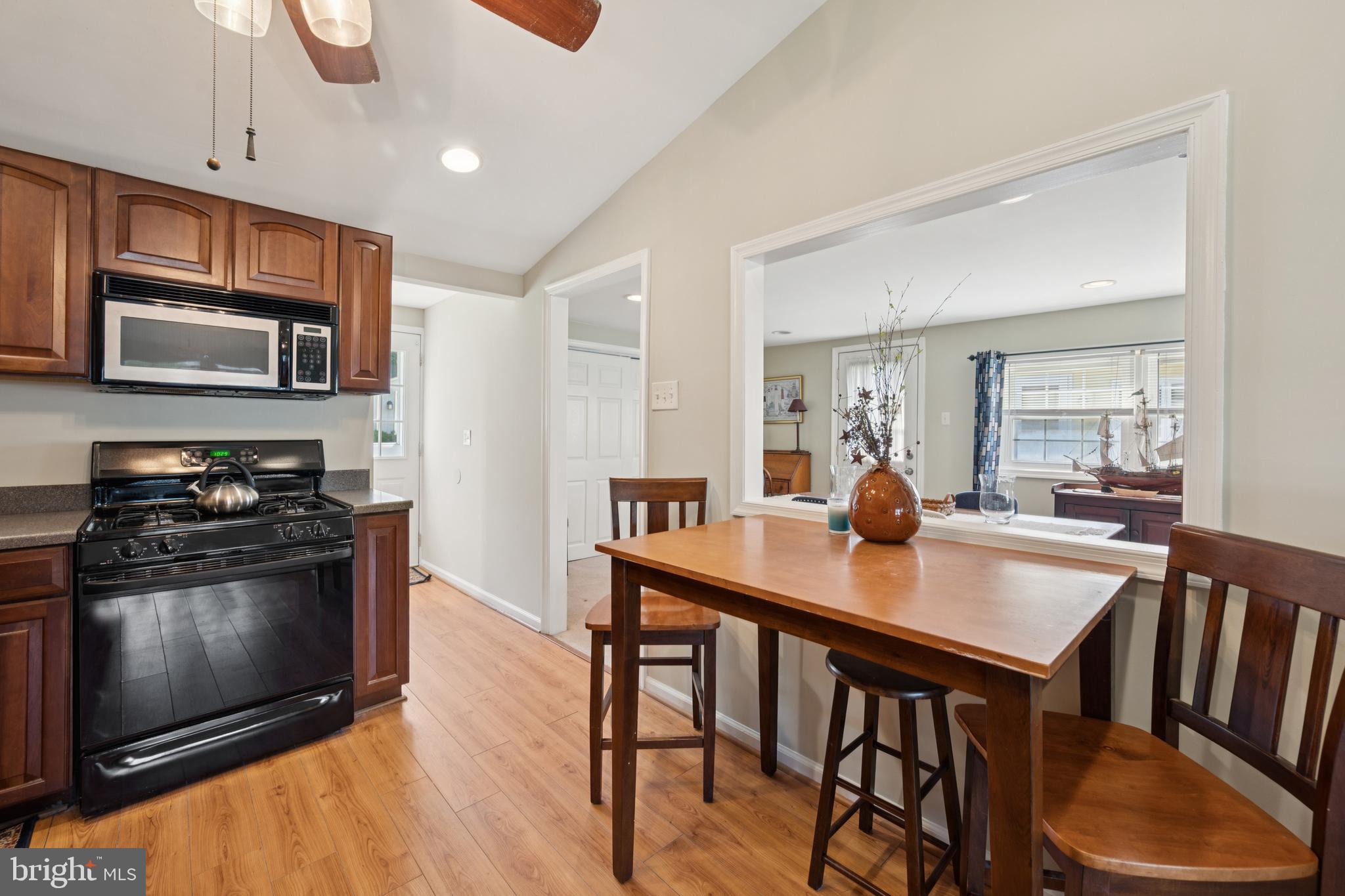 641 North Coles Avenue Maple Shade, NJ 08052 - Photo 5 of 23 a kitchen with stainless steel appliances wooden floor dining table and chairs