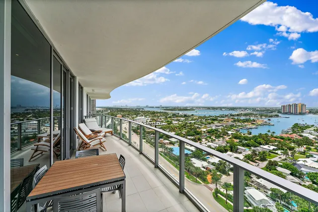 a view of a balcony with chair and wooden floor