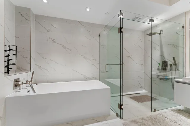 a bathroom with a bathtub and a shower