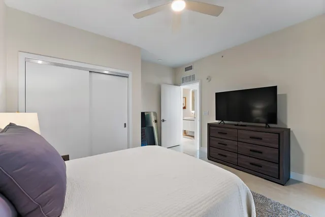 a bedroom with a bed and a flat screen tv