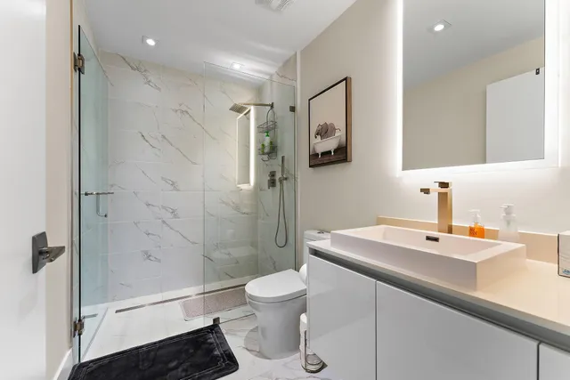 a bathroom with a sink toilet and shower