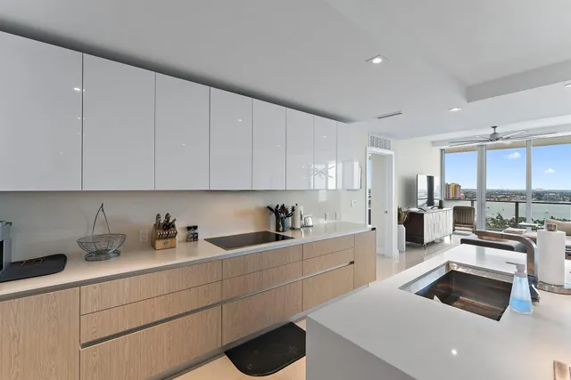 a kitchen with sink a stove and cabinets